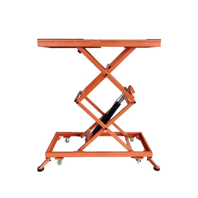 Orange electric scissor lift table in raised position