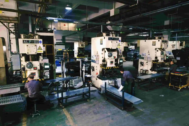 Professional operators managing heavy-duty metal stamping and fabrication machines in KINGRISE facility.