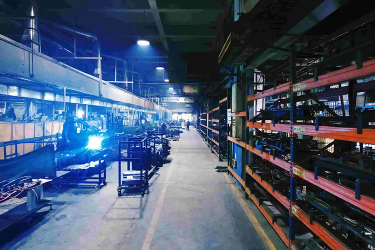 Inside the KINGRISE factory workshop showing heavy-duty material storage racks and manufacturing area.