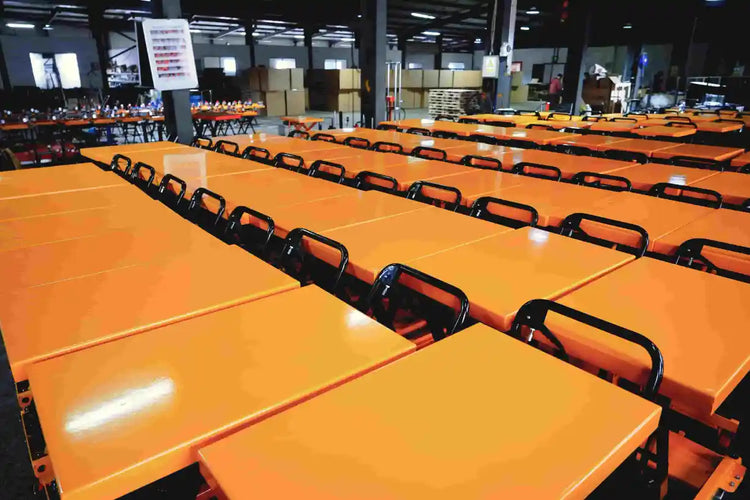 Rows of bright orange lift table platforms during the high-volume mass production stage at KINGRISE factory.